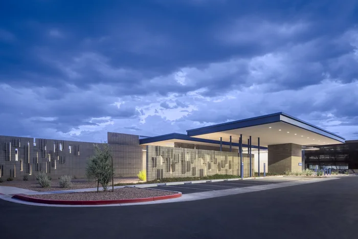 Maricopa County Animal Care Center: a long low building under a heavy sky, with a curved drop-off drive.