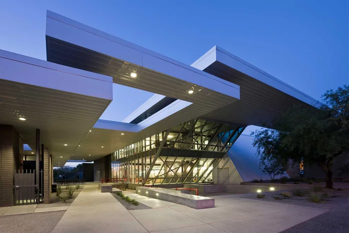University of Arizona Poetry Center: a deep white canopy cantilevered over the entrance, lit at dusk.